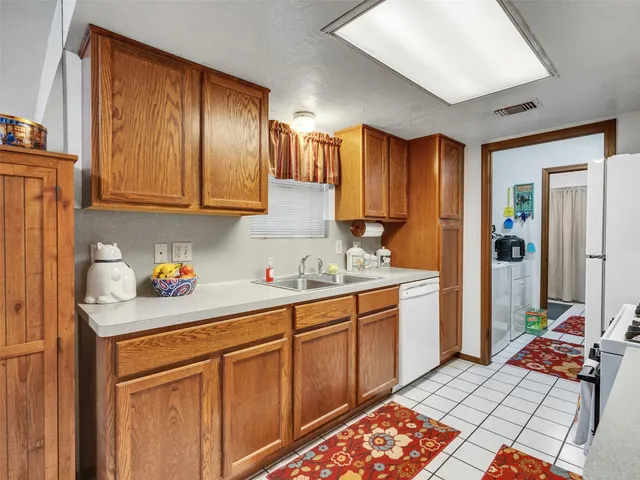 a kitchen with stainless steel appliances granite countertop a stove and a sink