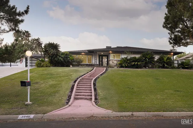 a swimming pool with outdoor seating and yard