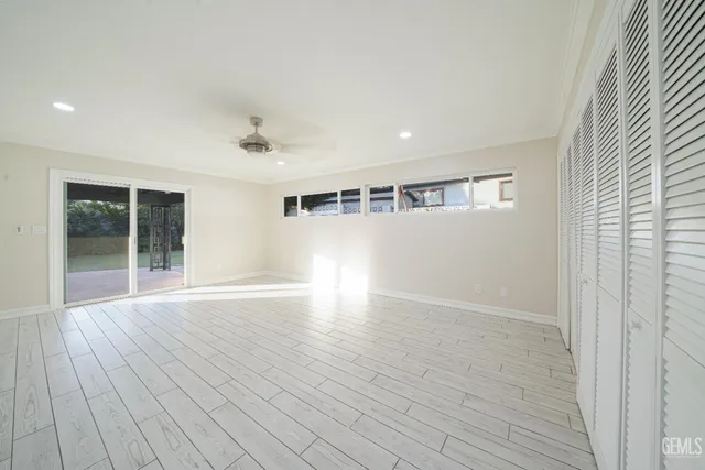 a view of an empty room with wooden floor