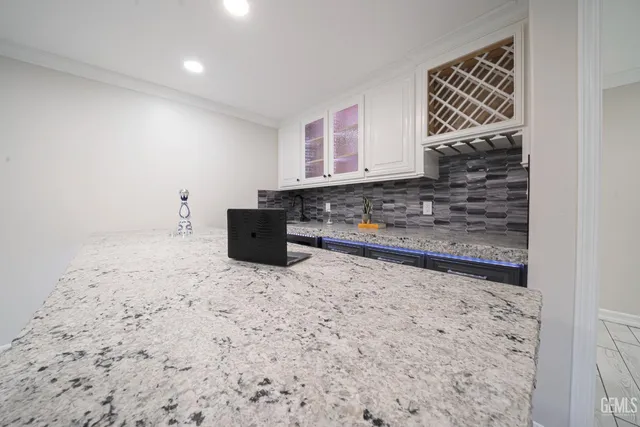 a kitchen with stainless steel appliances granite countertop a sink and a counter space