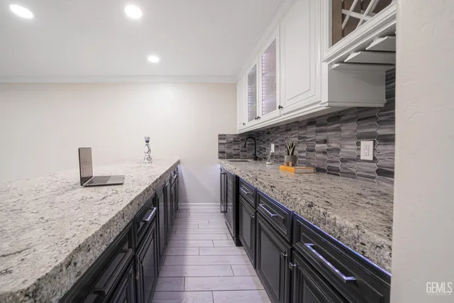 a kitchen with stainless steel appliances granite countertop a stove and a sink