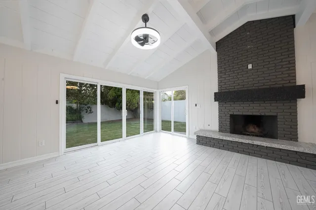 wooden floor in an empty room with a fireplace