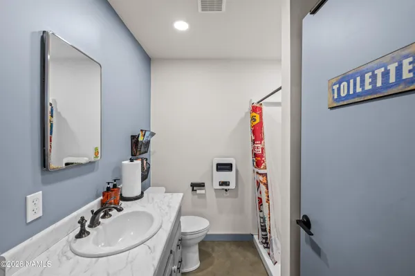a bathroom with a sink toilet and a mirror