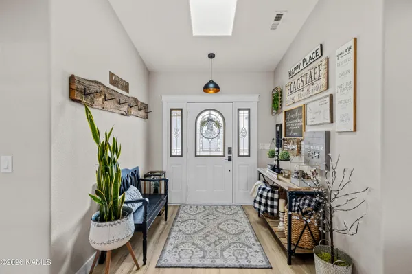 a view of entryway with wooden floor