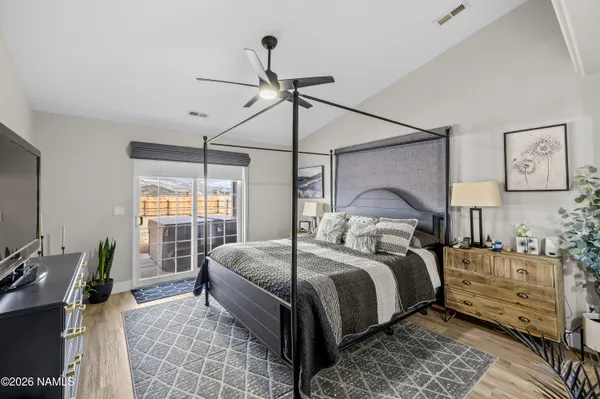 a bedroom with a large bed and a window