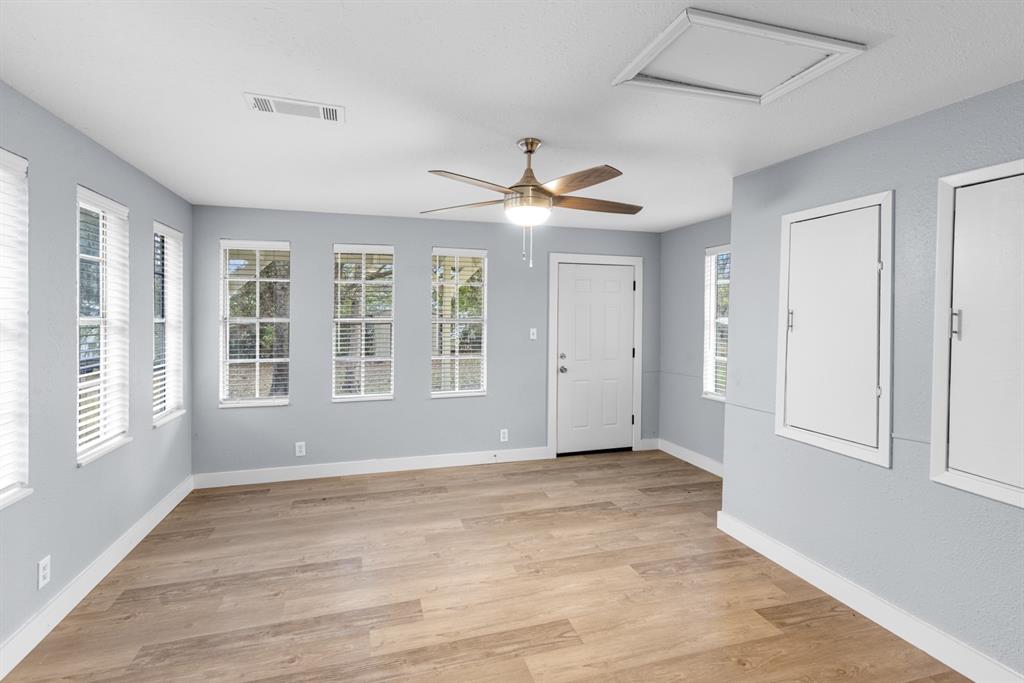 10474 Apache Street Wills Point, TX 75169 - Photo 12 of 29 a view of an empty room with a window and a kitchen