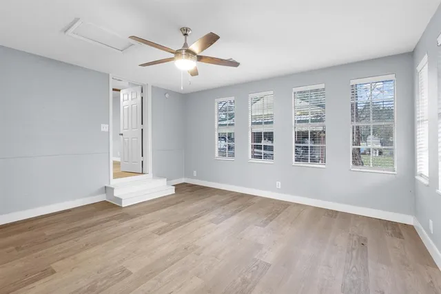 wooden floor in an empty room with a window