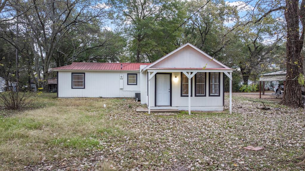 10474 Apache Street Wills Point, TX 75169 - Photo 3 of 29 a house with trees in the background