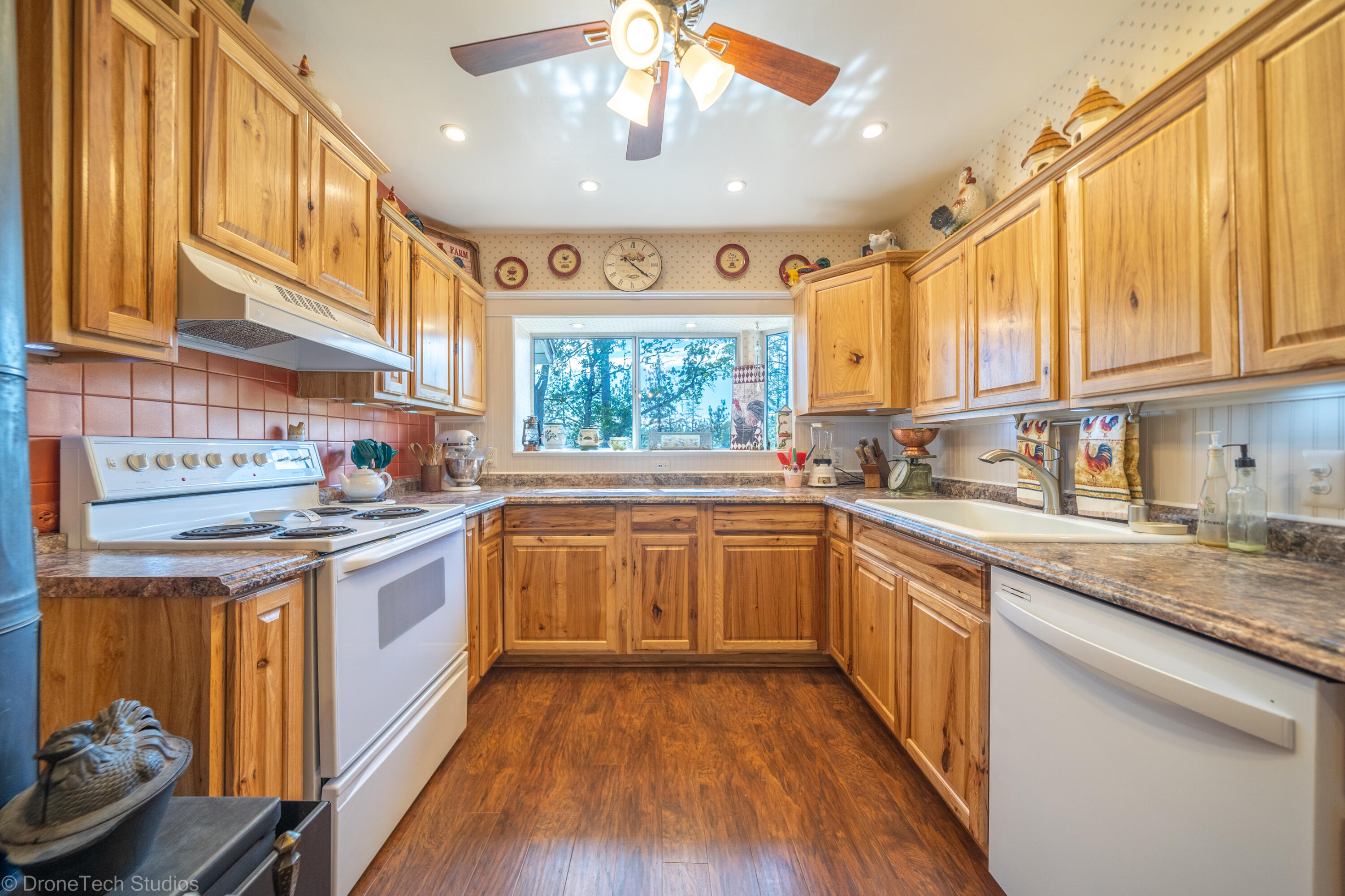 31250 2 Ponds Road Whitmore, CA 96096 - Photo 17 of 60 a kitchen with stainless steel appliances granite countertop a stove and a sink