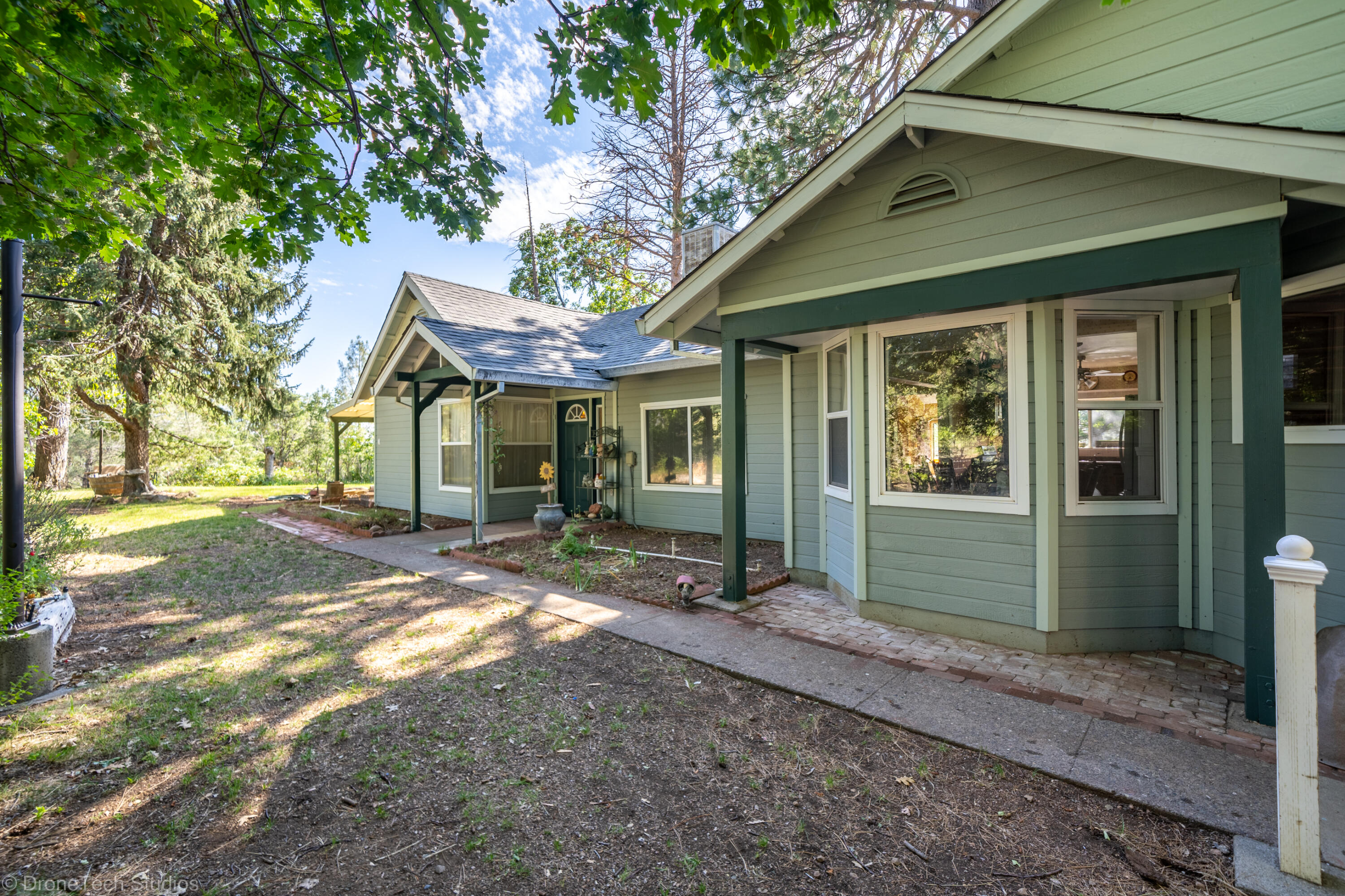 31250 2 Ponds Road Whitmore, CA 96096 - Photo 7 of 60 a front view of a house with a garden
