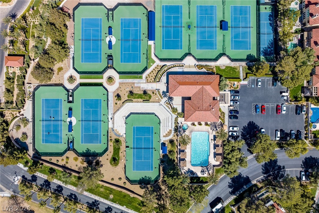 20 Innisbrook Avenue Las Vegas, NV 89113 - Photo 32 of 39 An aerial perspective showcases a vibrant community with tennis courts, a sparkling pool, and ample parking.