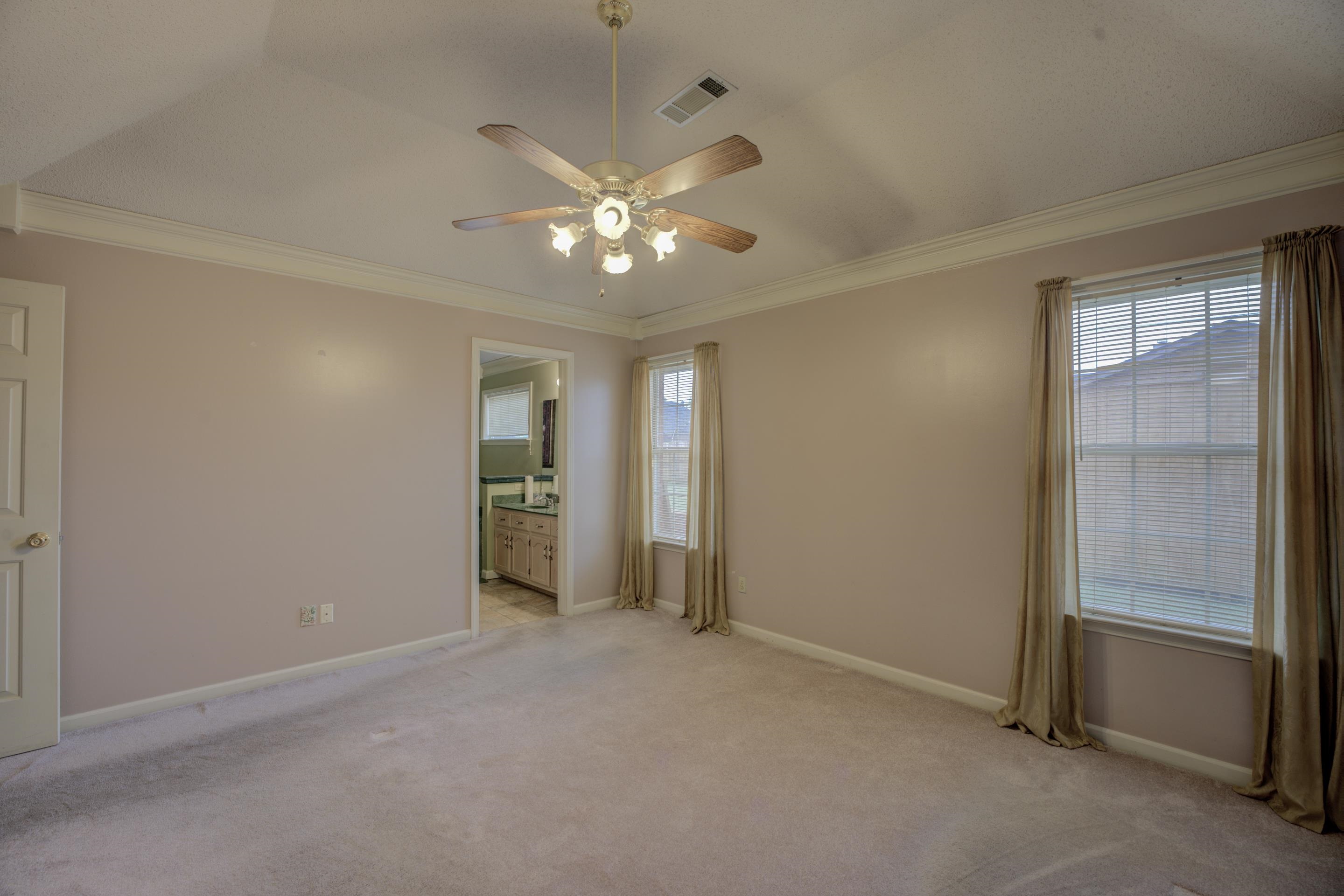 7657 Stone Manor Road Memphis, TN 38125 - Photo 12 of 27 Empty room featuring ornamental molding, light carpet, and ceiling fan