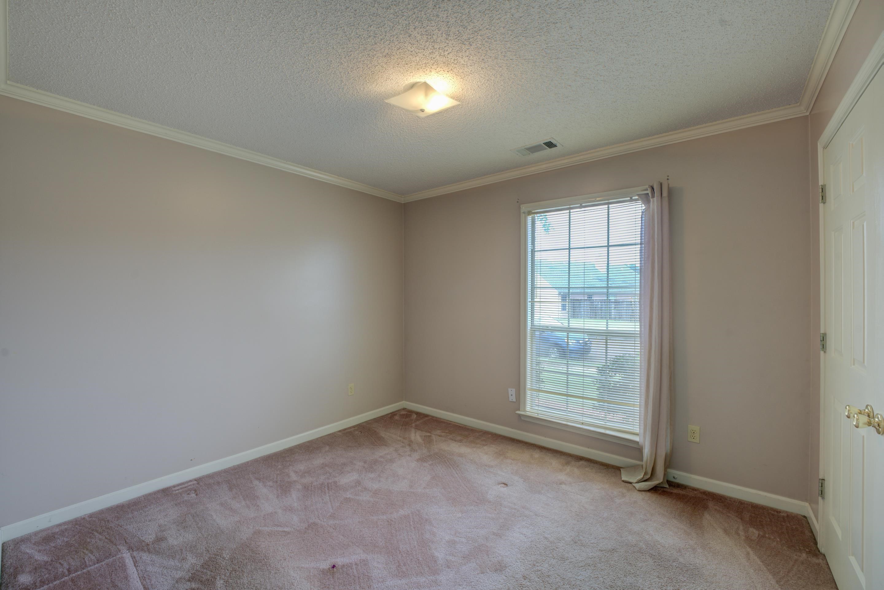 7657 Stone Manor Road Memphis, TN 38125 - Photo 19 of 27 Spare room with a textured ceiling, light carpet, and crown molding