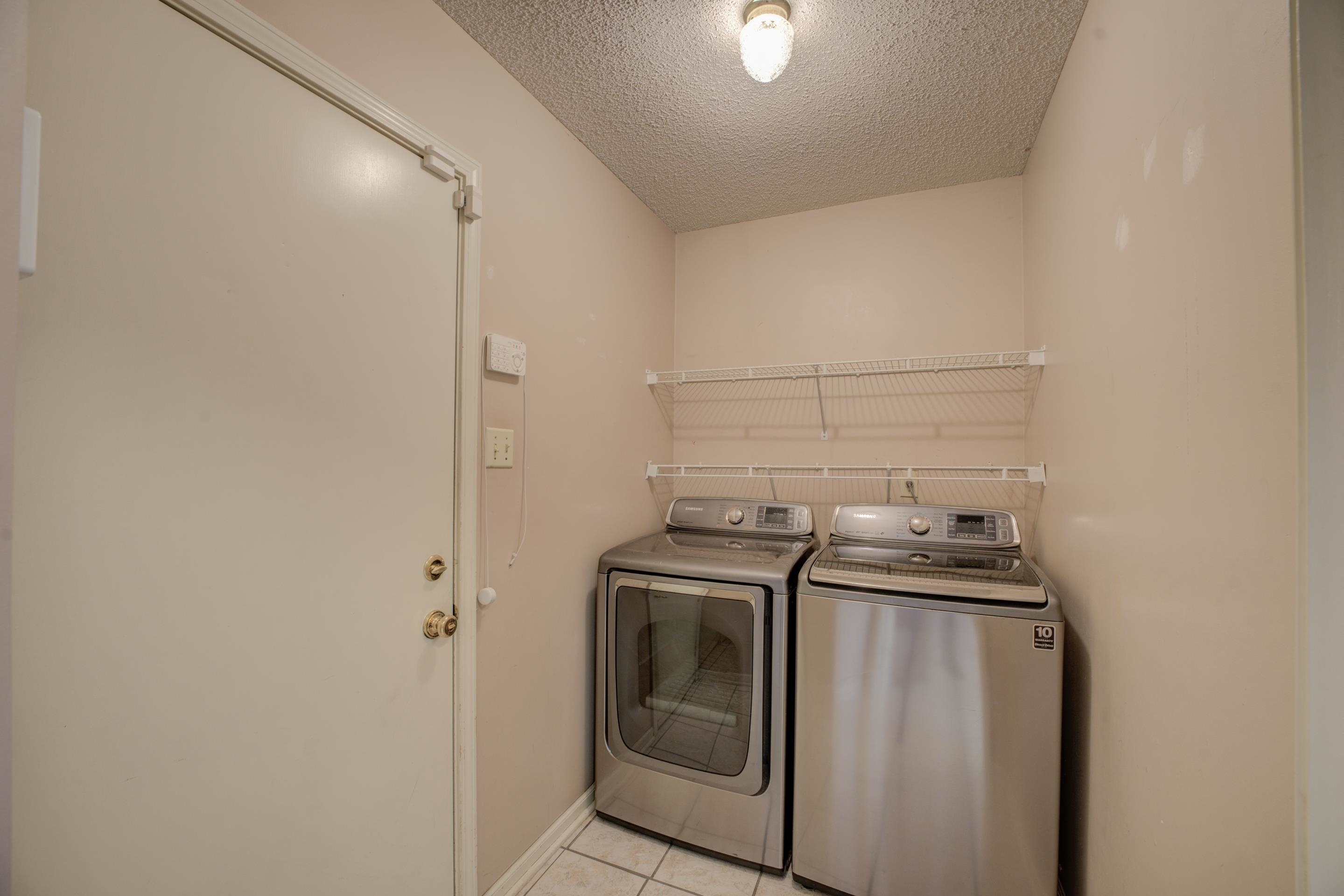 7657 Stone Manor Road Memphis, TN 38125 - Photo 21 of 27 Clothes washing area with a textured ceiling, independent washer and dryer, and light tile patterned flooring