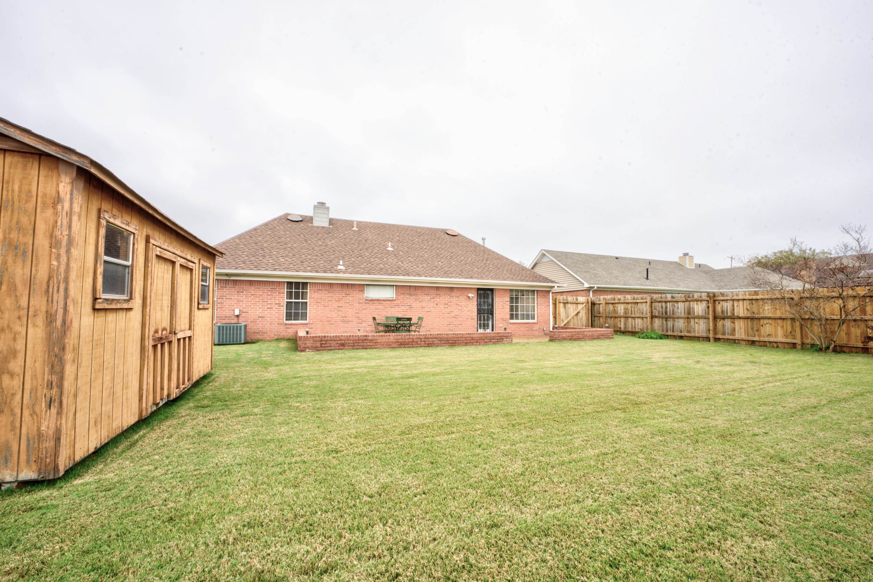7657 Stone Manor Road Memphis, TN 38125 - Photo 26 of 27 View of yard featuring central air condition unit and a patio