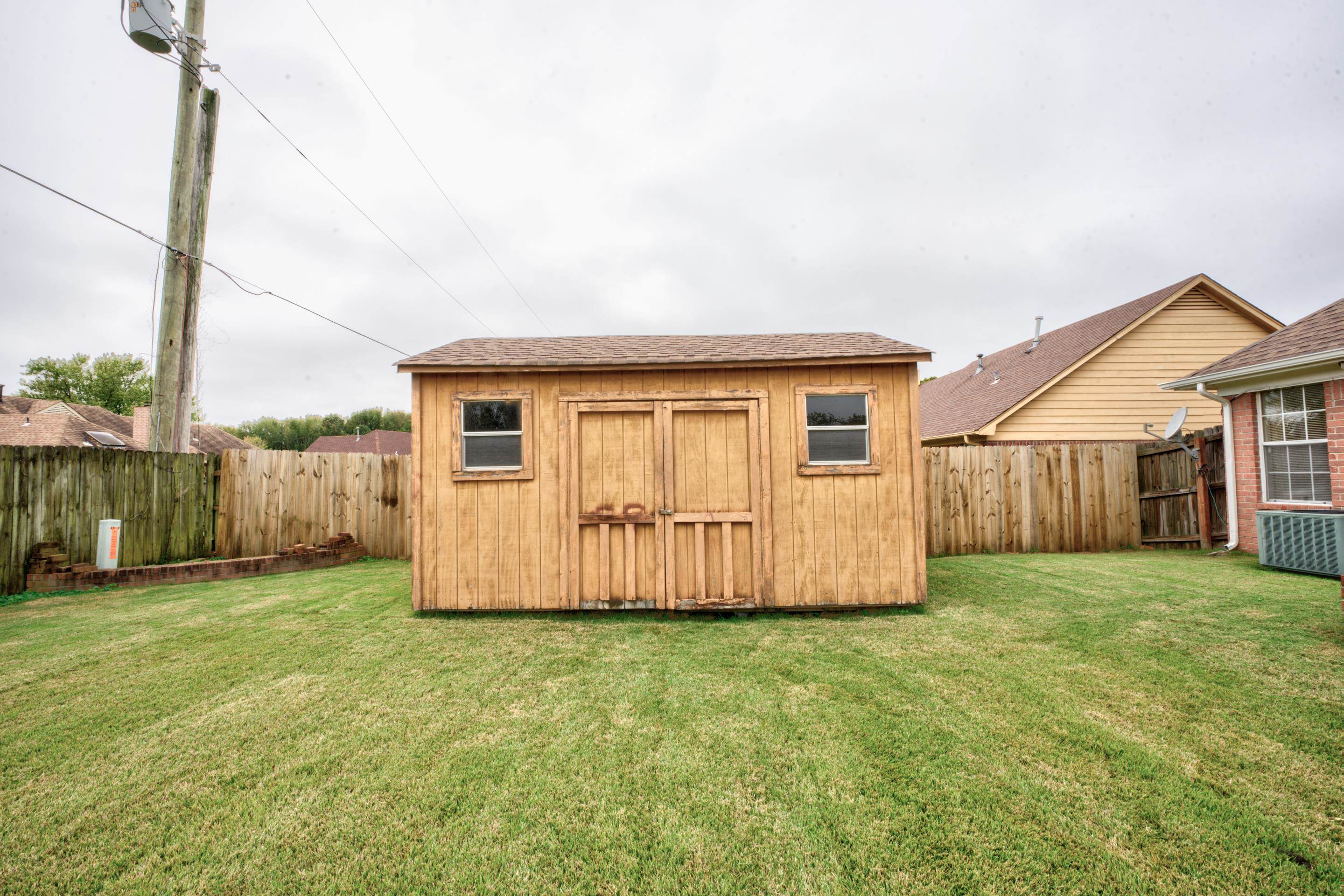 7657 Stone Manor Road Memphis, TN 38125 - Photo 27 of 27 View of outbuilding with central AC unit and a lawn