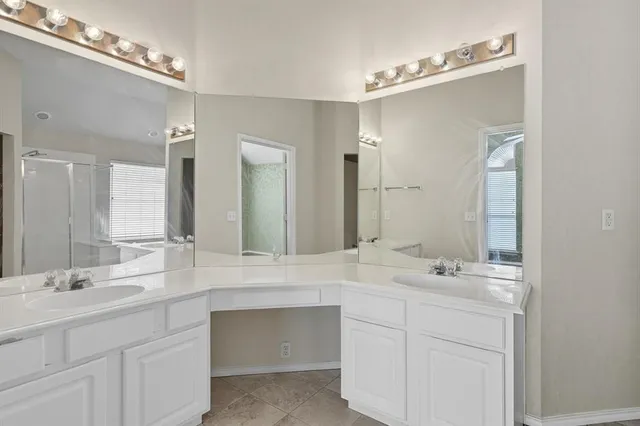 a bathroom with a sink double vanity and a mirror