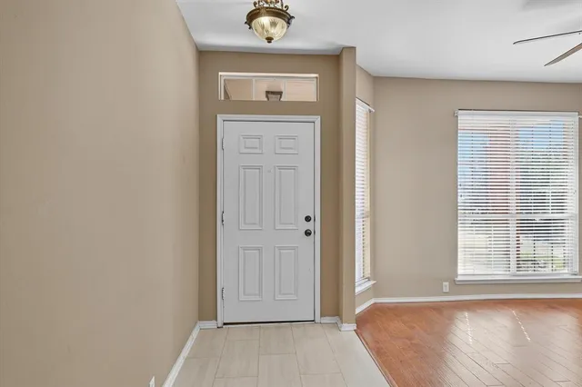 a view of a bedroom with a bed and a window