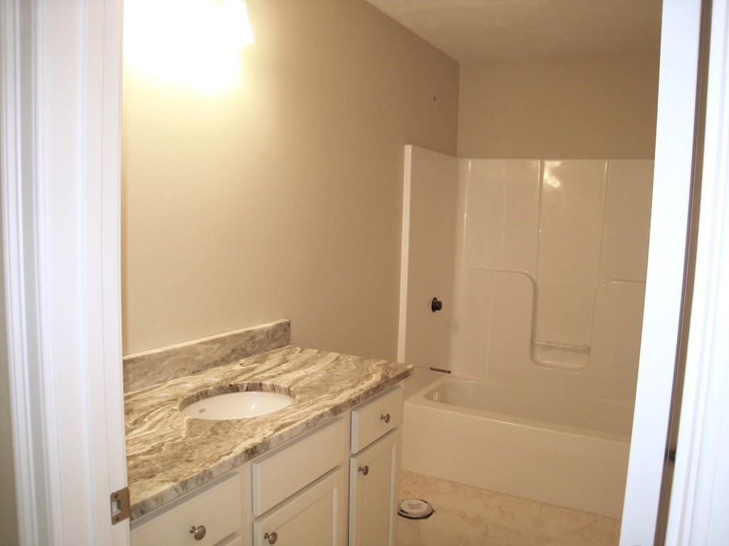 81 Partridge Hill Road Sutton, MA 01590 - Photo 21 of 23 a bathroom with a granite countertop sink a toilet and shower