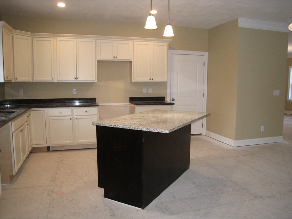 81 Partridge Hill Road Sutton, MA 01590 - Photo 4 of 23 a kitchen with granite countertop white cabinets and stainless steel appliances