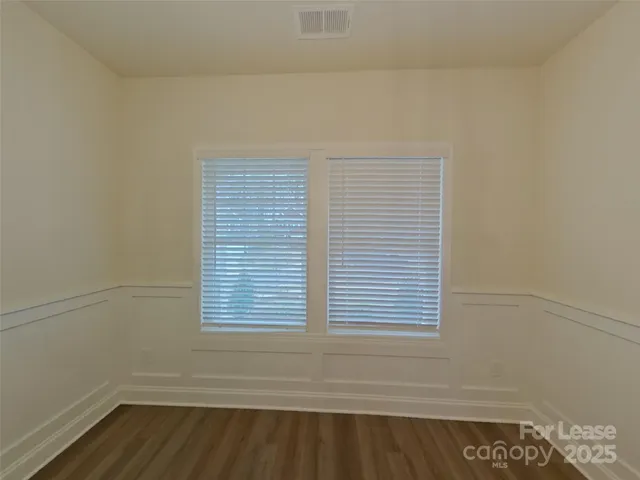 a view of a closet area with wooden floor