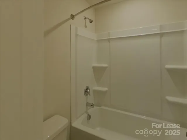 a bathroom with a shower and a toilet