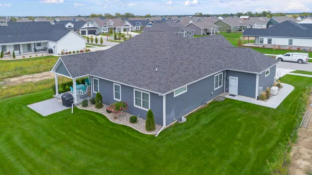 an aerial view of a house with a big yard and large trees