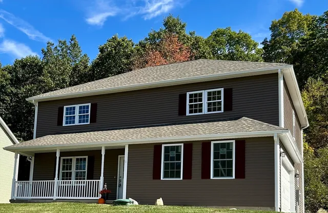 a front view of a house with a garden