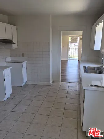 a kitchen with a sink a stove and cabinets
