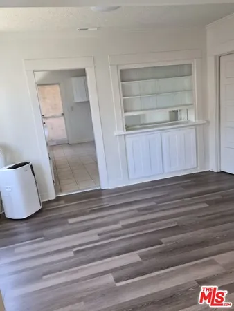 a view of staircase and closet with wooden floor