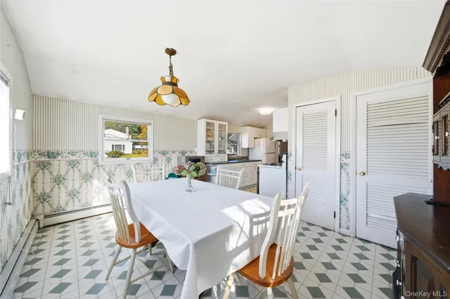 a dining room with furniture a window and a chandelier