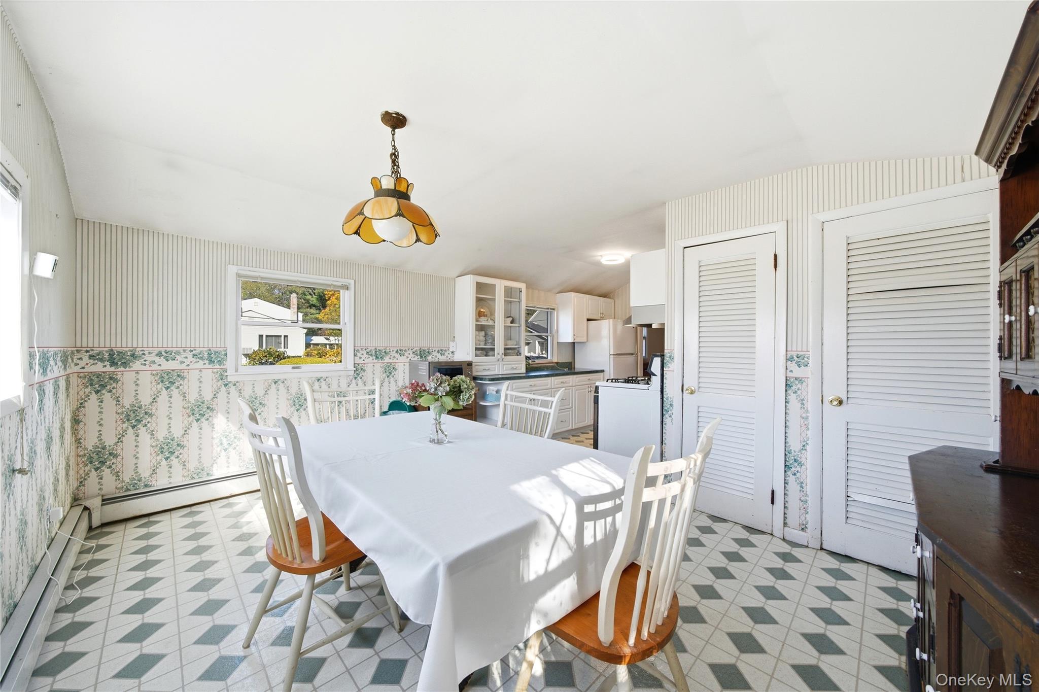 68 7th Street Bay Shore, NY 11706 - Photo 12 of 21 a dining room with furniture a window and a chandelier