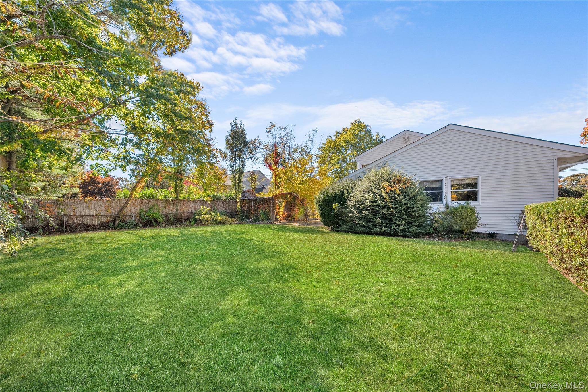 68 7th Street Bay Shore, NY 11706 - Photo 20 of 21 a view of a house with a yard and a garden