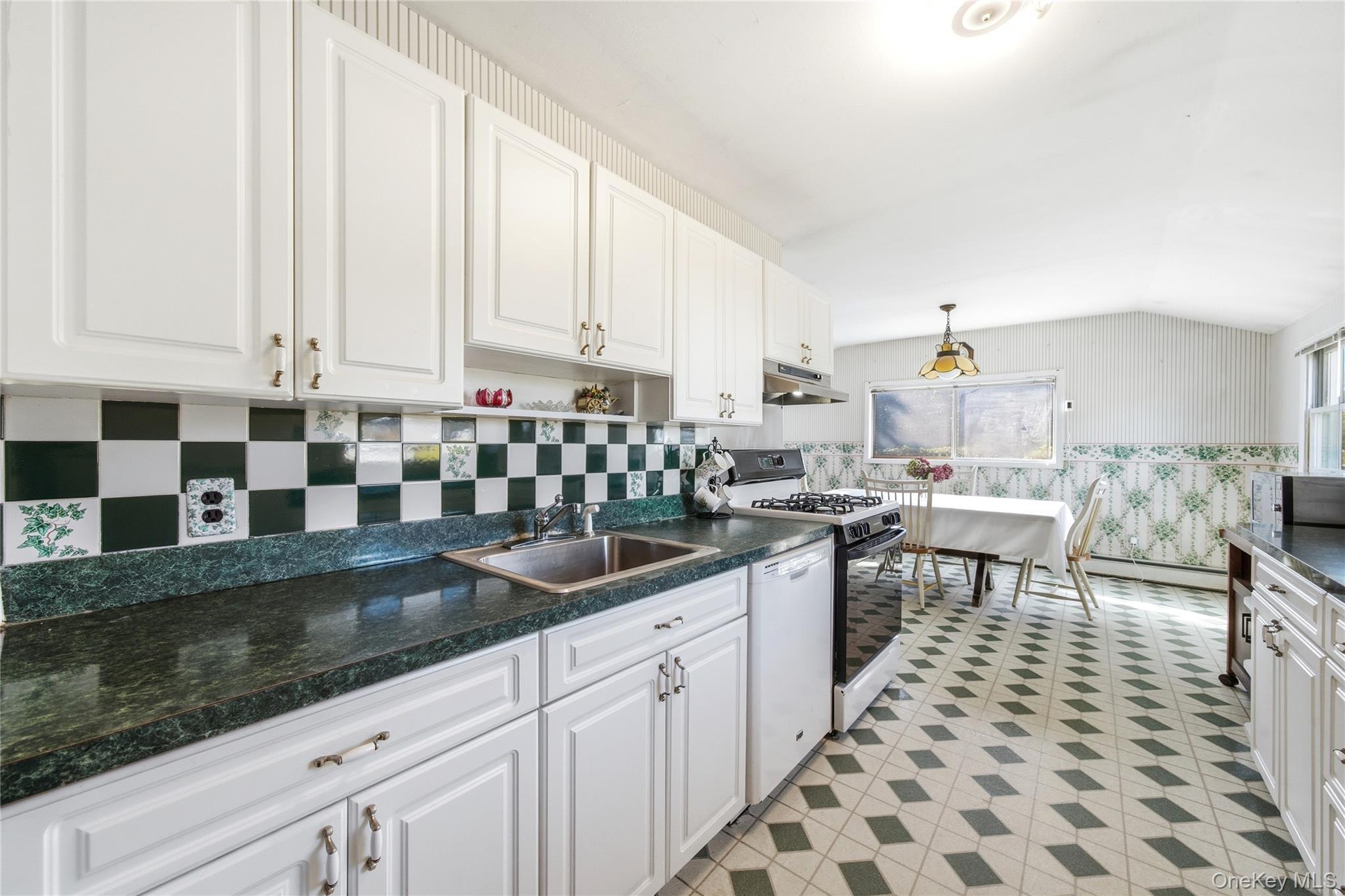 68 7th Street Bay Shore, NY 11706 - Photo 8 of 21 a kitchen with stainless steel appliances granite countertop a sink and cabinets