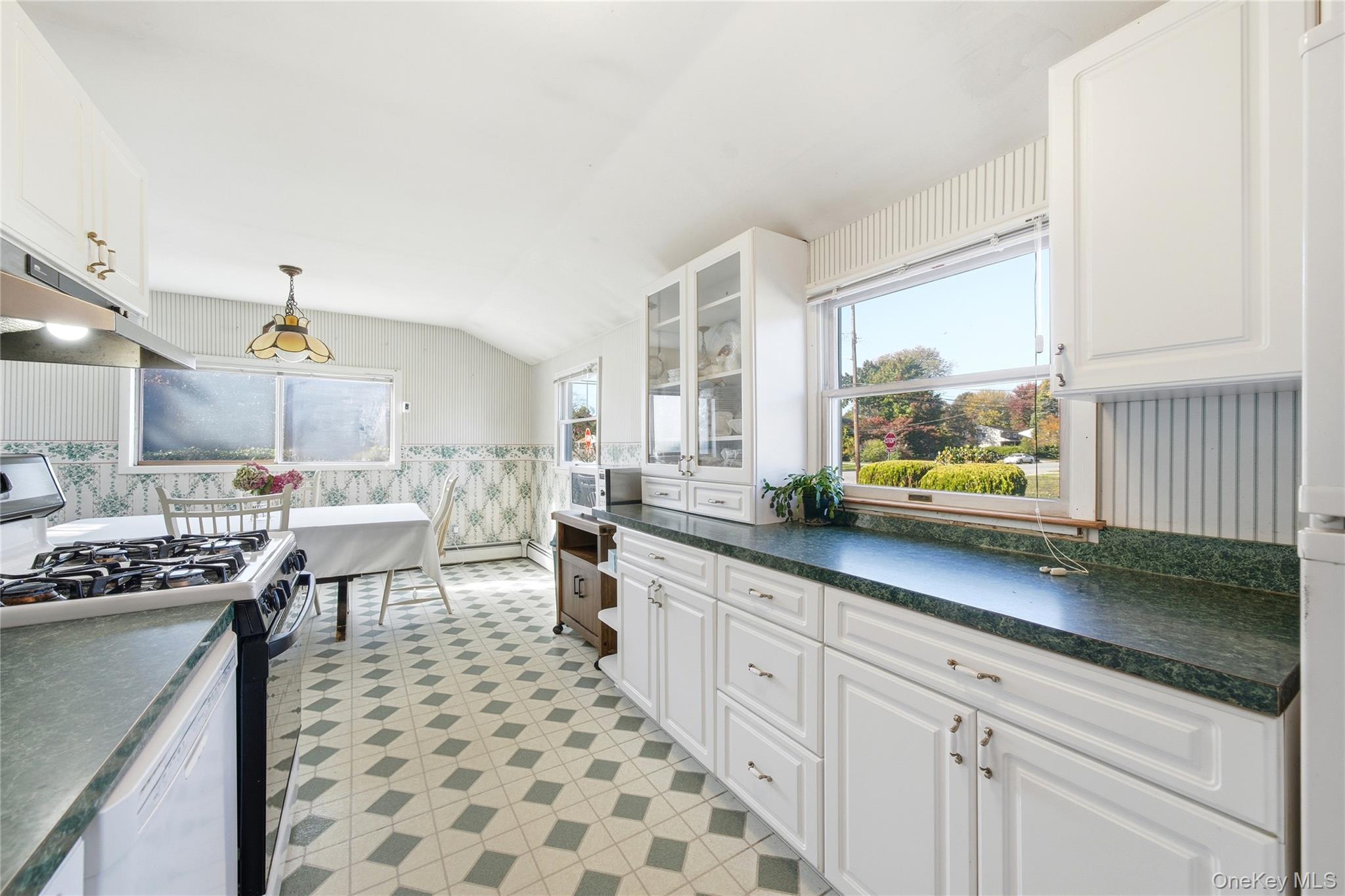 68 7th Street Bay Shore, NY 11706 - Photo 9 of 21 a kitchen with lots of counter top space and dining table