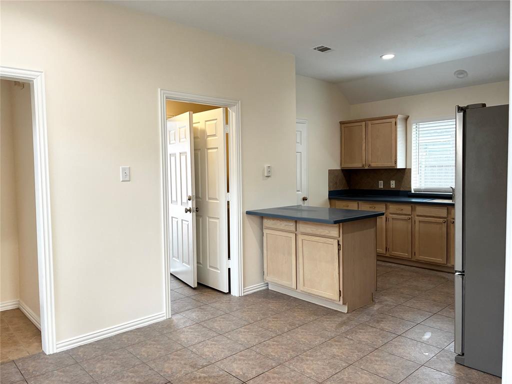 7936 Tournament Road Frisco, TX 75035 - Photo 12 of 28 a kitchen with granite countertop a sink cabinets and stainless steel appliances