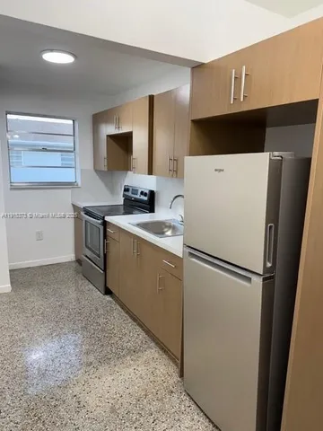 a white refrigerator freezer sitting in a kitchen