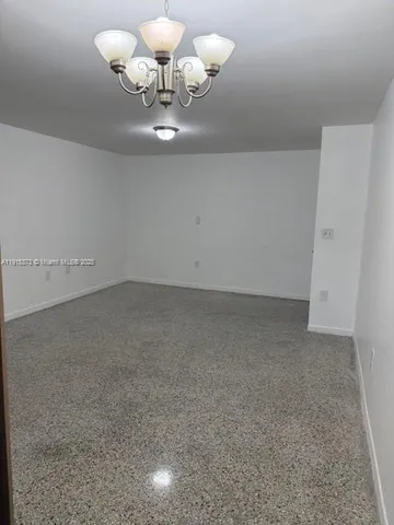 a view of room with chandelier
