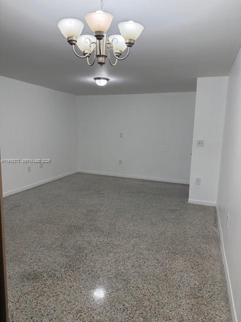 1685 West 41st Street, Unit 5 Hialeah, FL 33012 - Photo 4 of 9 a view of room with chandelier