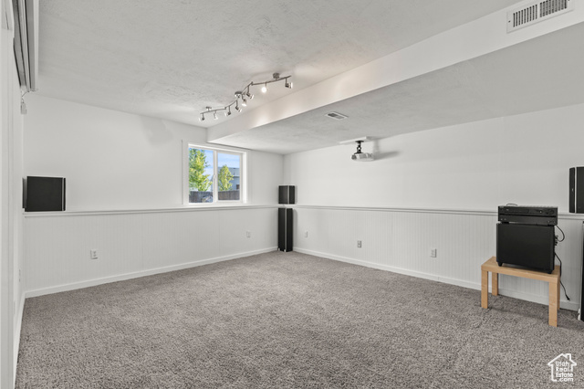 1099 Three Point Avenue Logan, UT 84321 - Photo 15 of 27 Empty room featuring carpet floors and wainscoting