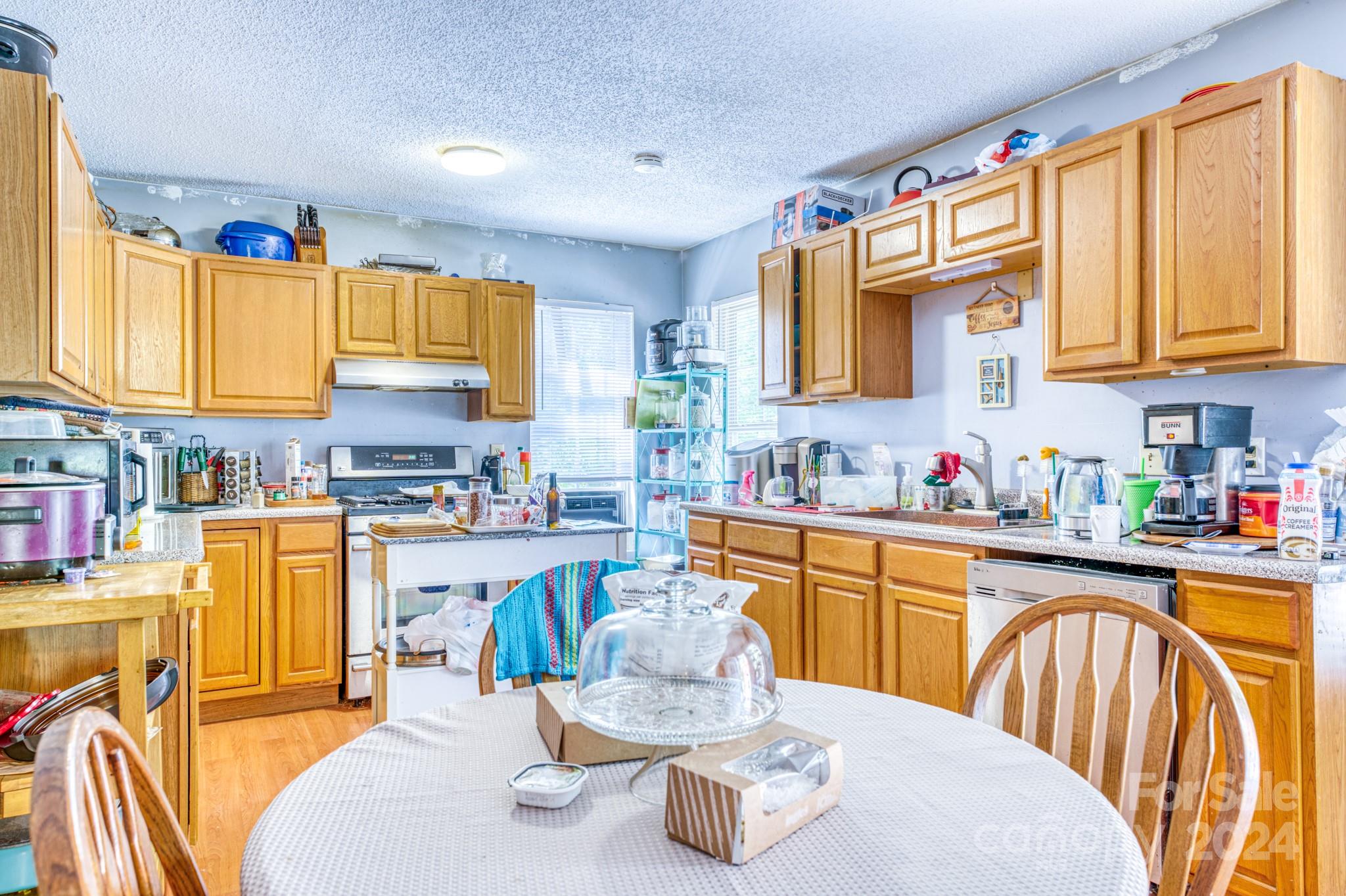 1 Westgate Road Asheville, NC 28806 - Photo 14 of 25 a kitchen with stainless steel appliances kitchen island granite countertop a sink and cabinets