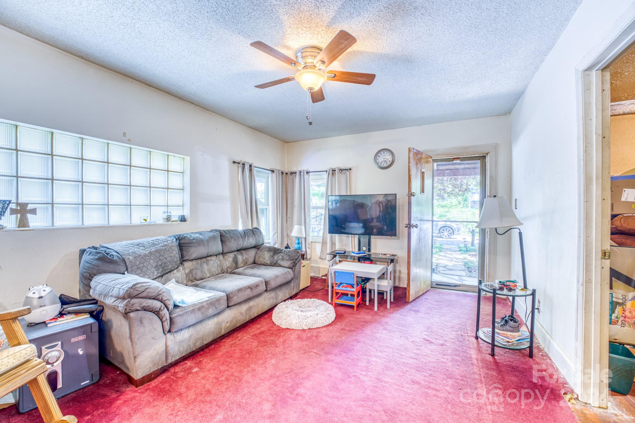 1 Westgate Road Asheville, NC 28806 - Photo 20 of 25 a living room with furniture and a flat screen tv