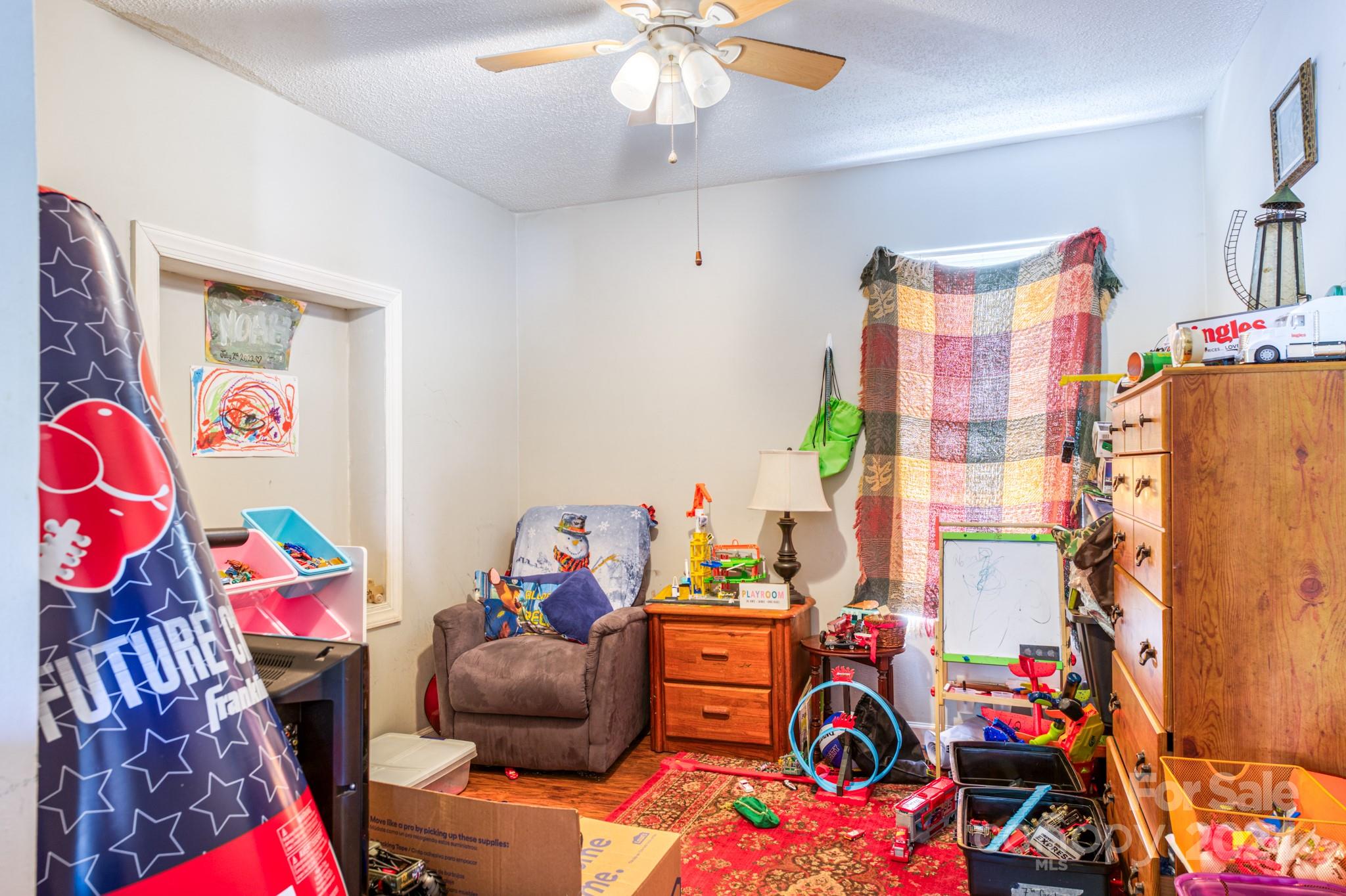 1 Westgate Road Asheville, NC 28806 - Photo 21 of 25 a bedroom with a bed and a chandelier
