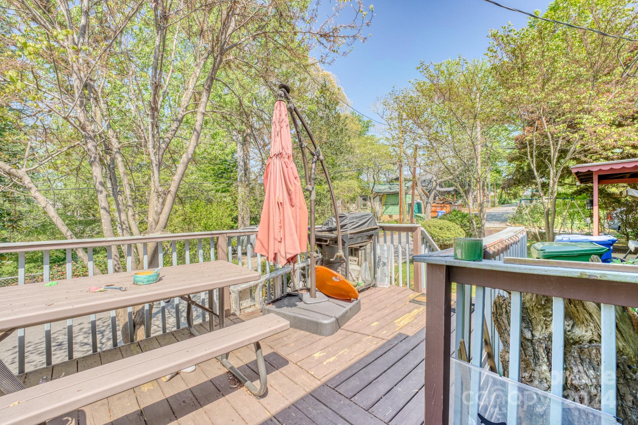 1 Westgate Road Asheville, NC 28806 - Photo 22 of 25 a view of a deck with two chair and wooden floor