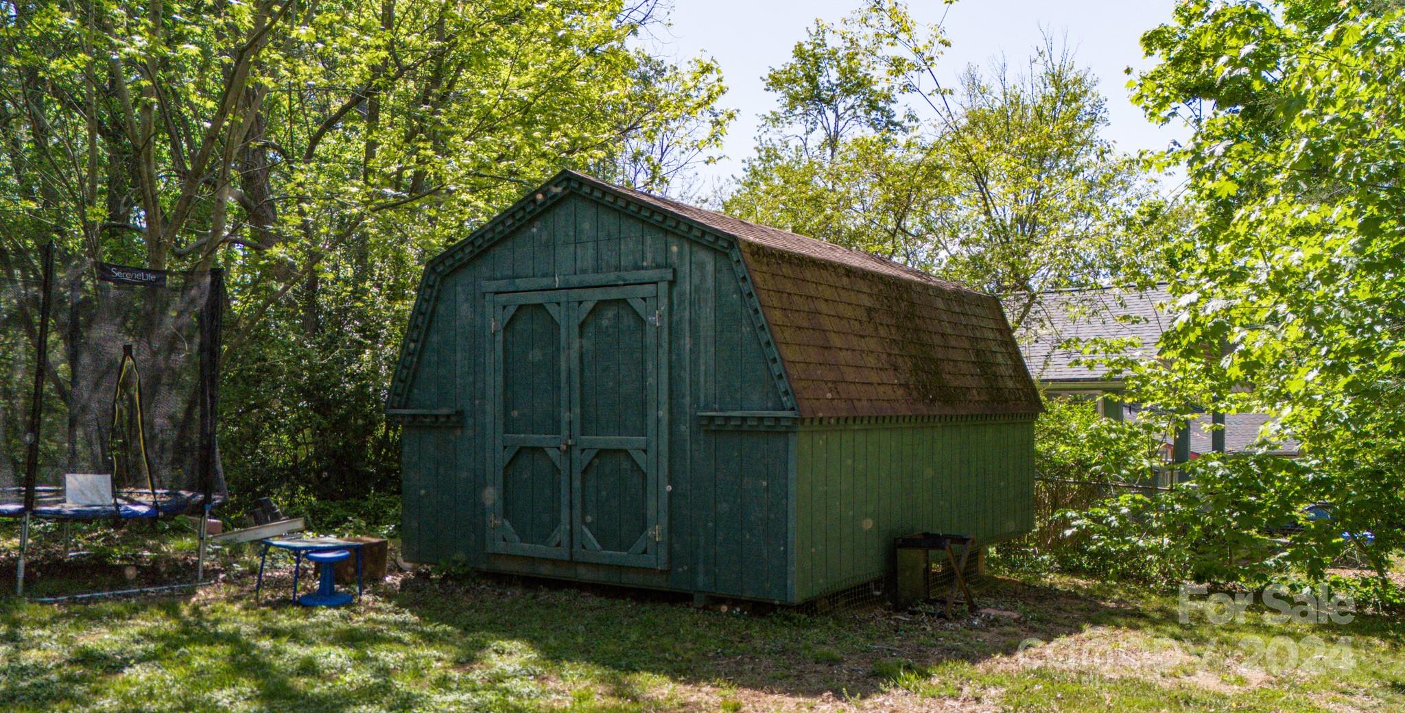 1 Westgate Road Asheville, NC 28806 - Photo 8 of 25 a view of backyard with potted plants and a large tree