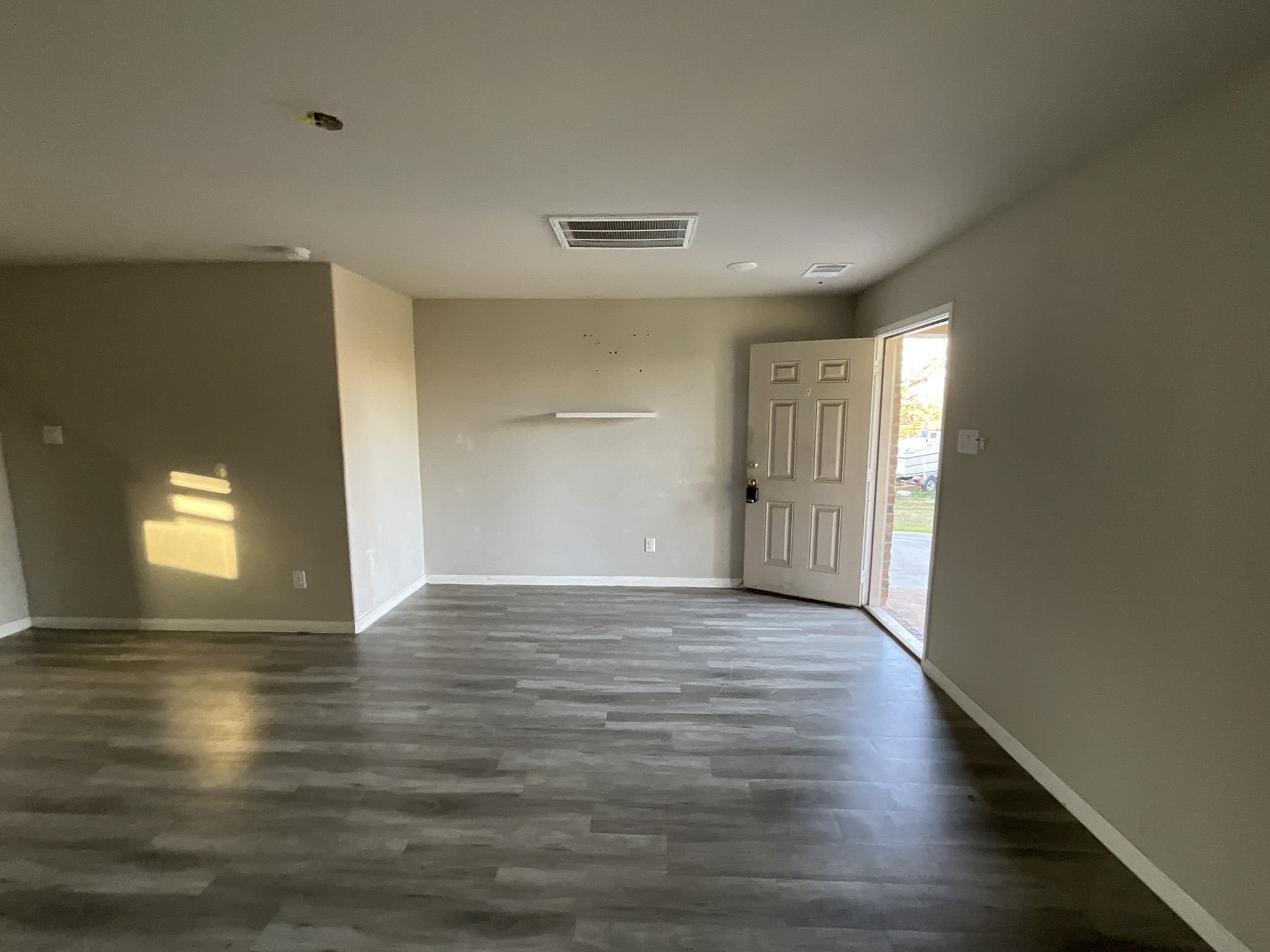 803 North Spanish Camp Road Wharton, TX 77488 - Photo 5 of 13 a view of an empty room with wooden floor and a window