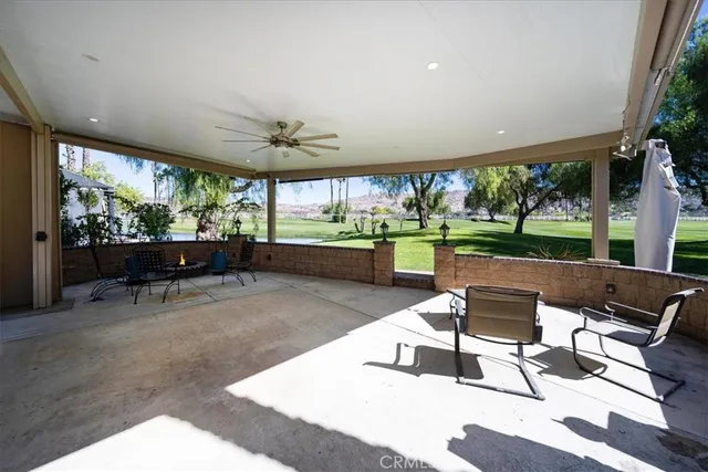 a living room with patio furniture and a floor to ceiling window