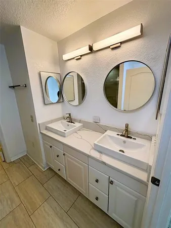 a bathroom with a double vanity sink and a mirror