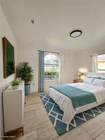 a bedroom with a large bed and a flat screen tv