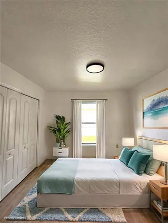 a bedroom with a bed and ceiling fan